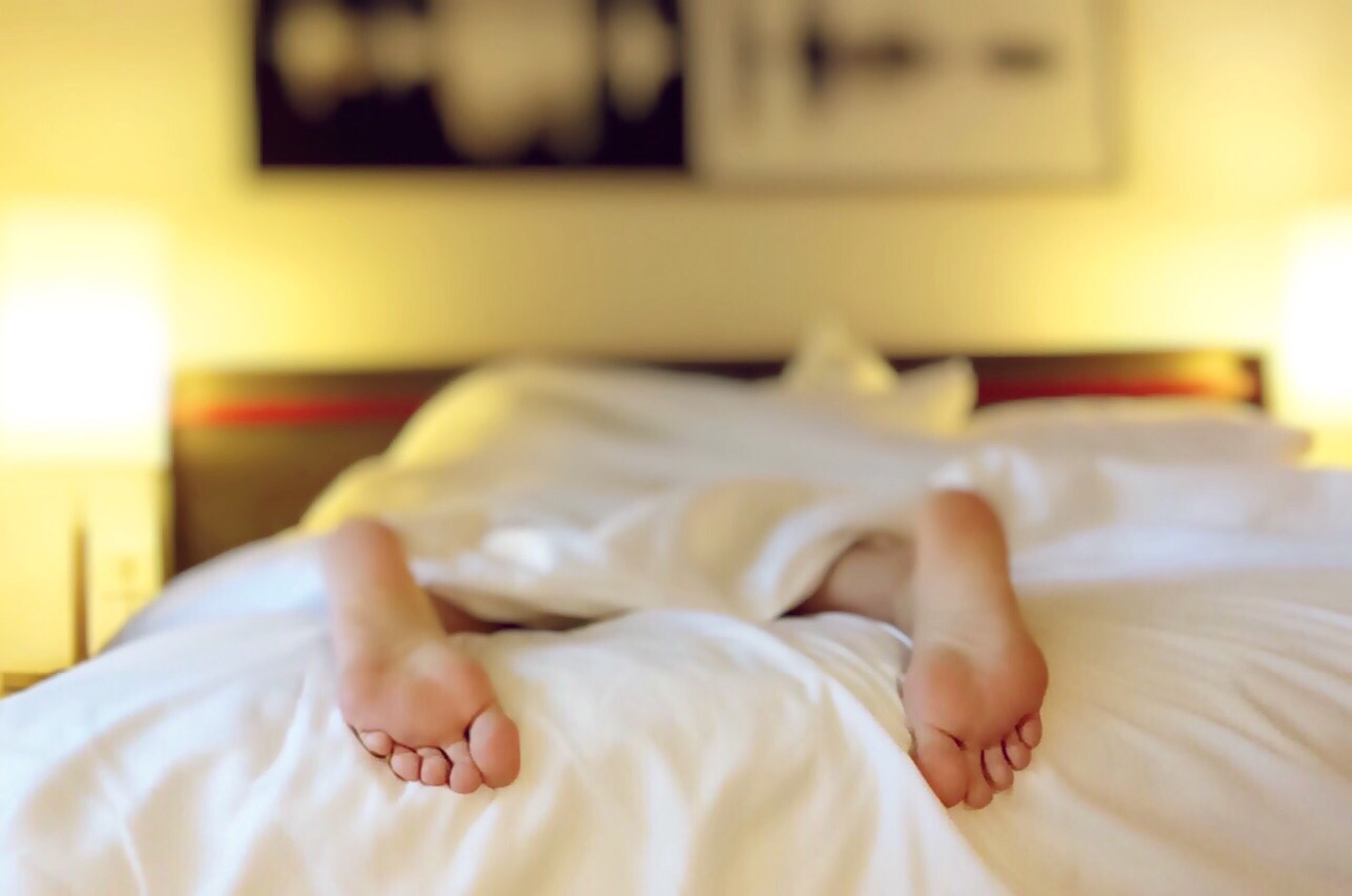 Looking at person sleeping with feet sticking out through their window blinds Glasgow. 