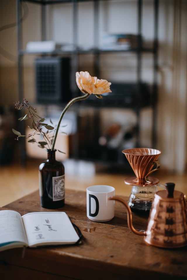 a mug and a kettle on a desk